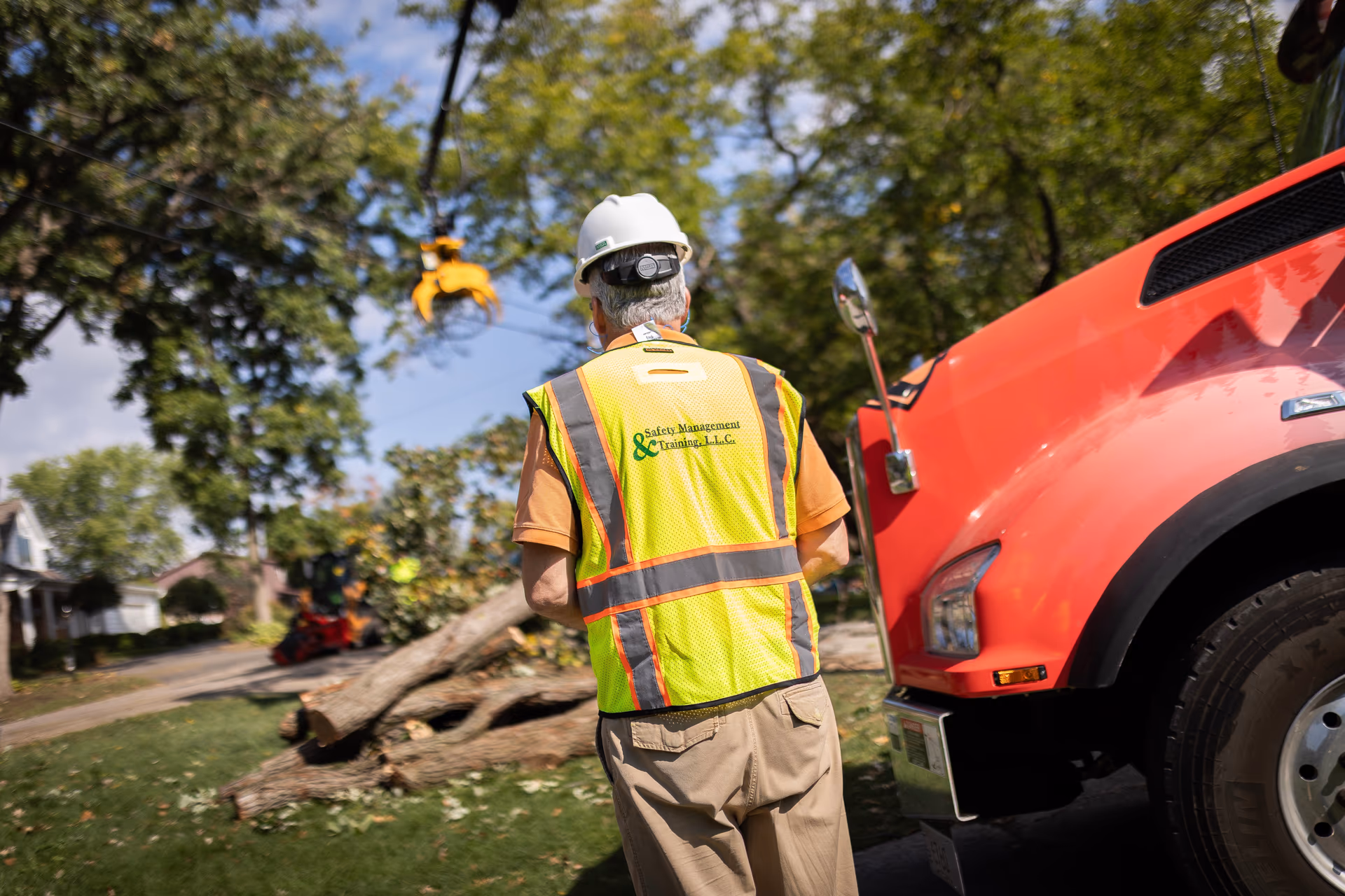 ISA Certified Arborist on site beside a Tree Wise Men crane truck in Janesville, Wisconsin