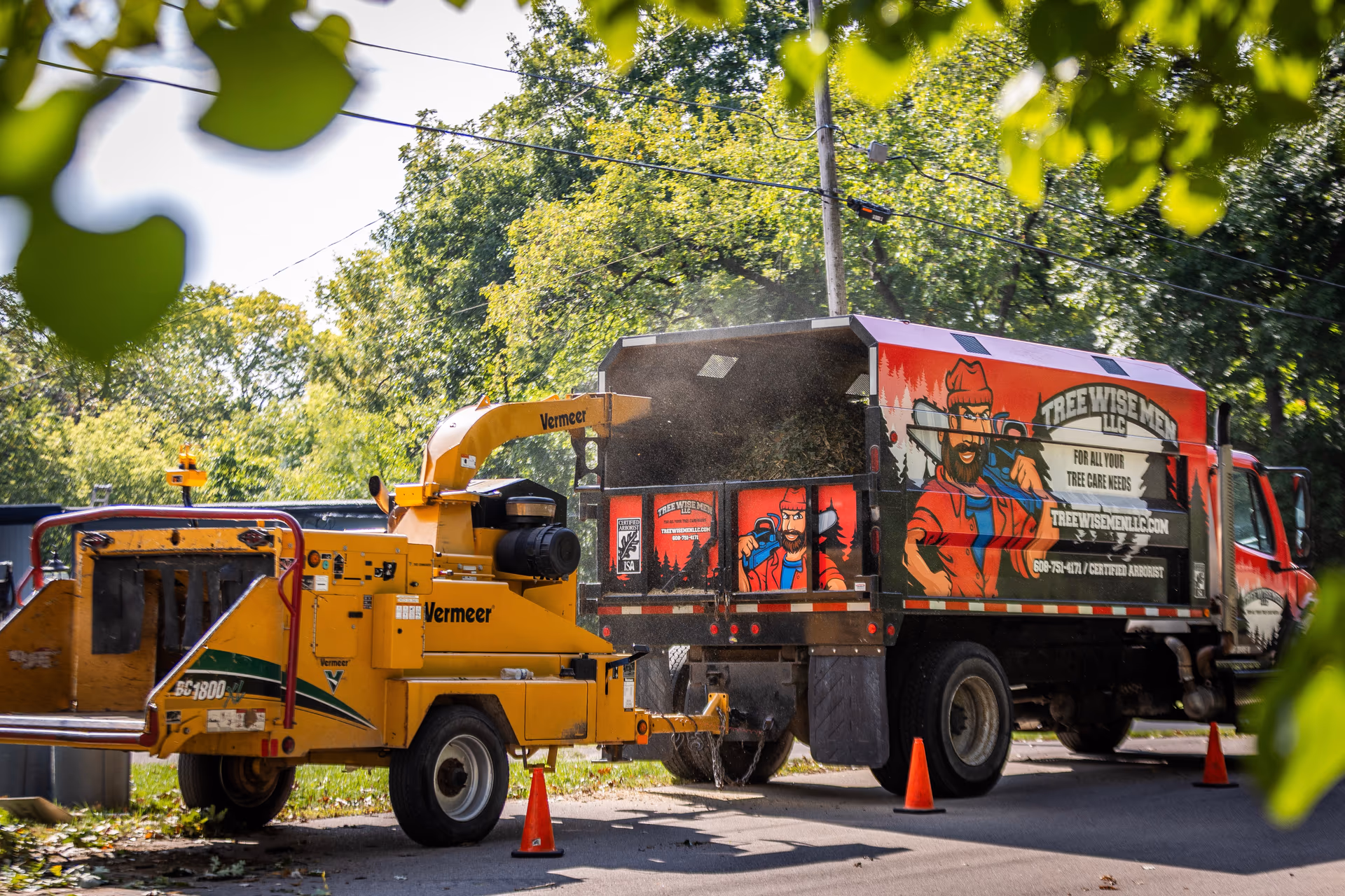Tree Wise Men truck and chipper set up on a residential street for pruning work