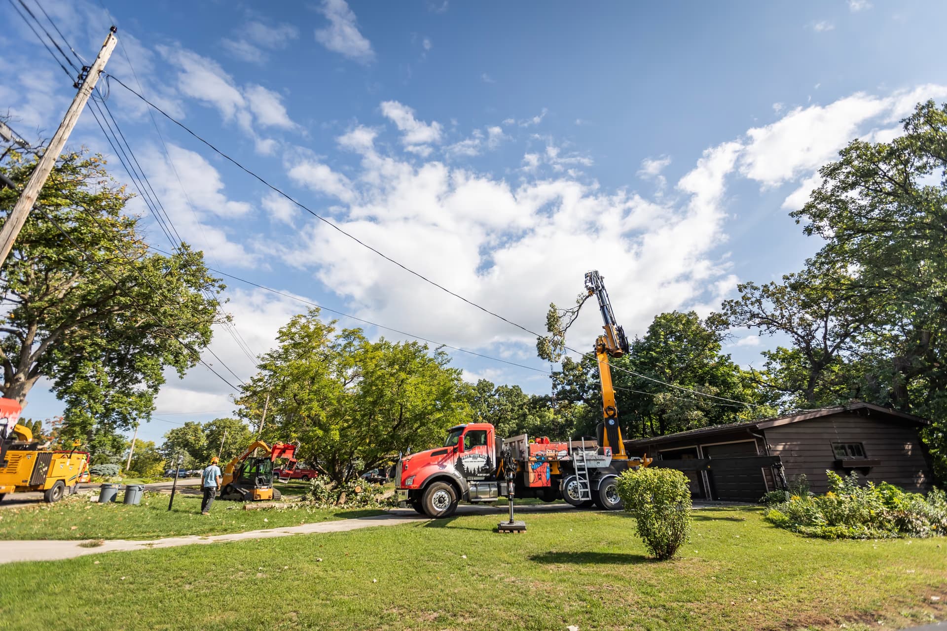 Crane Boom Extended Over the Neighborhood Canopy