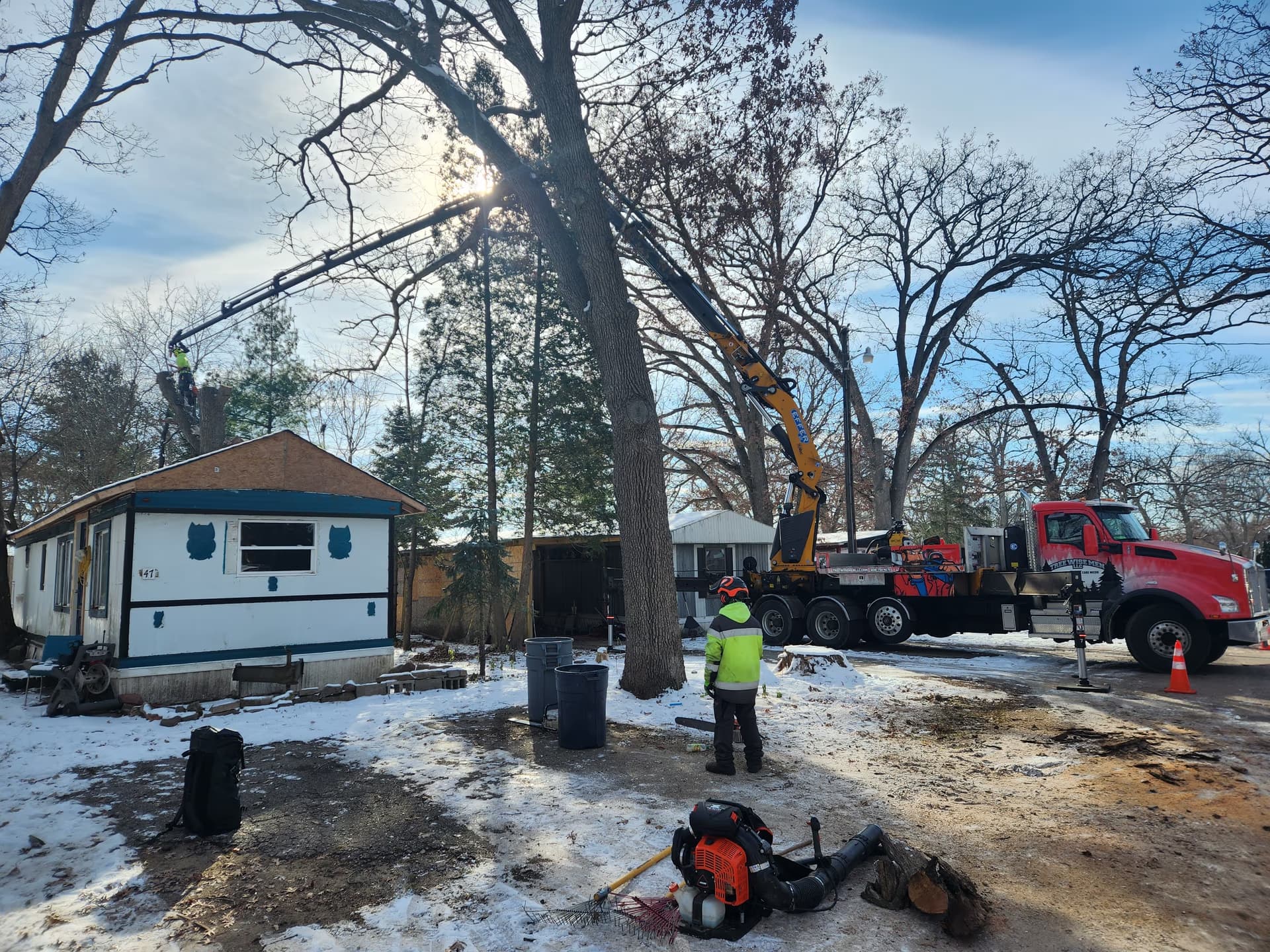 Tree Wise Men crane truck and crew on a winter residential tree removal in Dane County