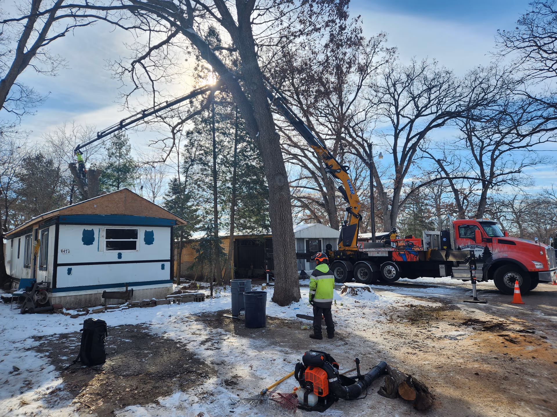 Tree Wise Men crane truck and crew on a winter residential tree removal in Dane County