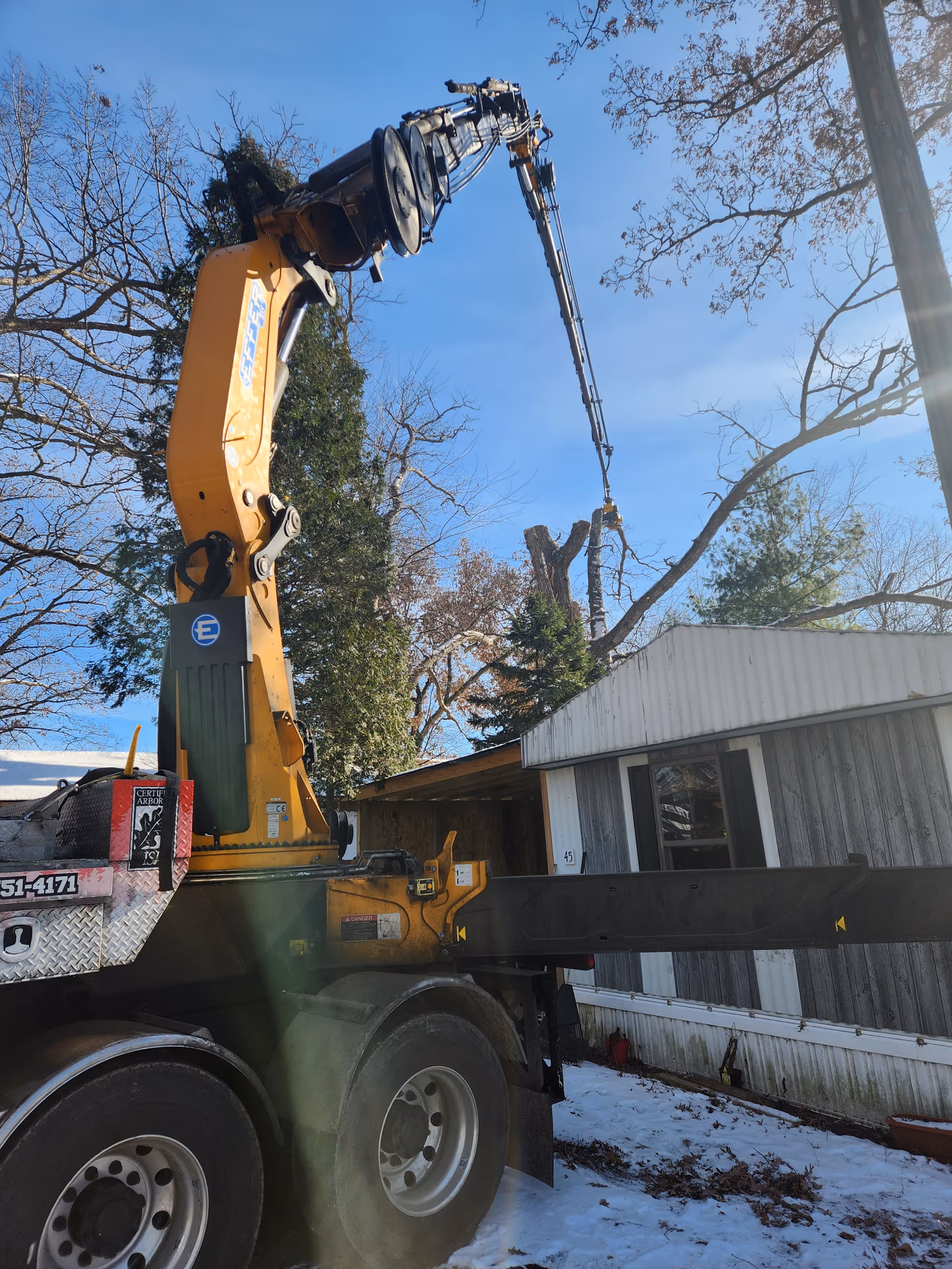 Crane truck working a tight-access emergency removal in Jefferson County, Wisconsin
