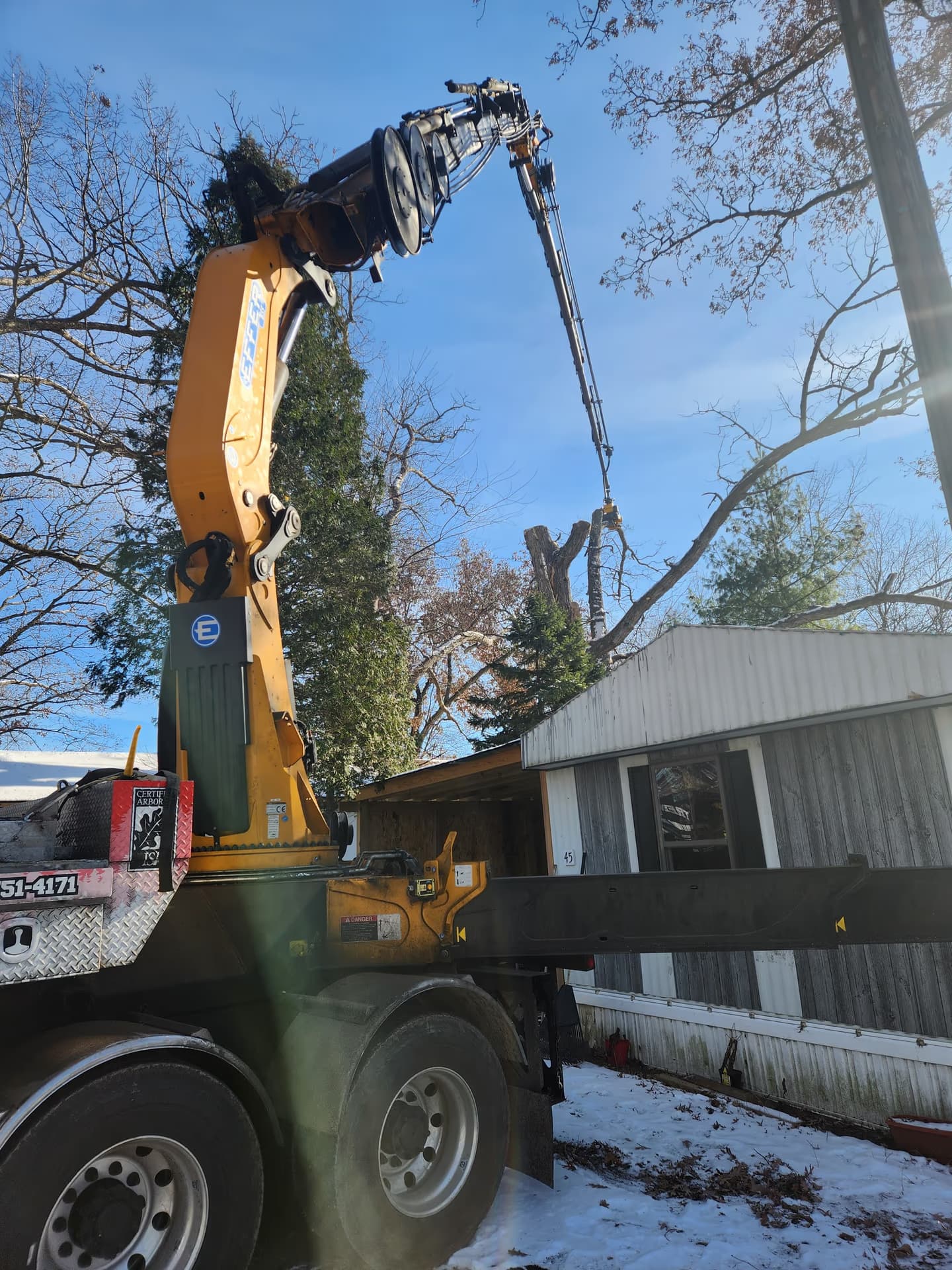 Crane truck working a tight-access emergency removal in Jefferson County, Wisconsin