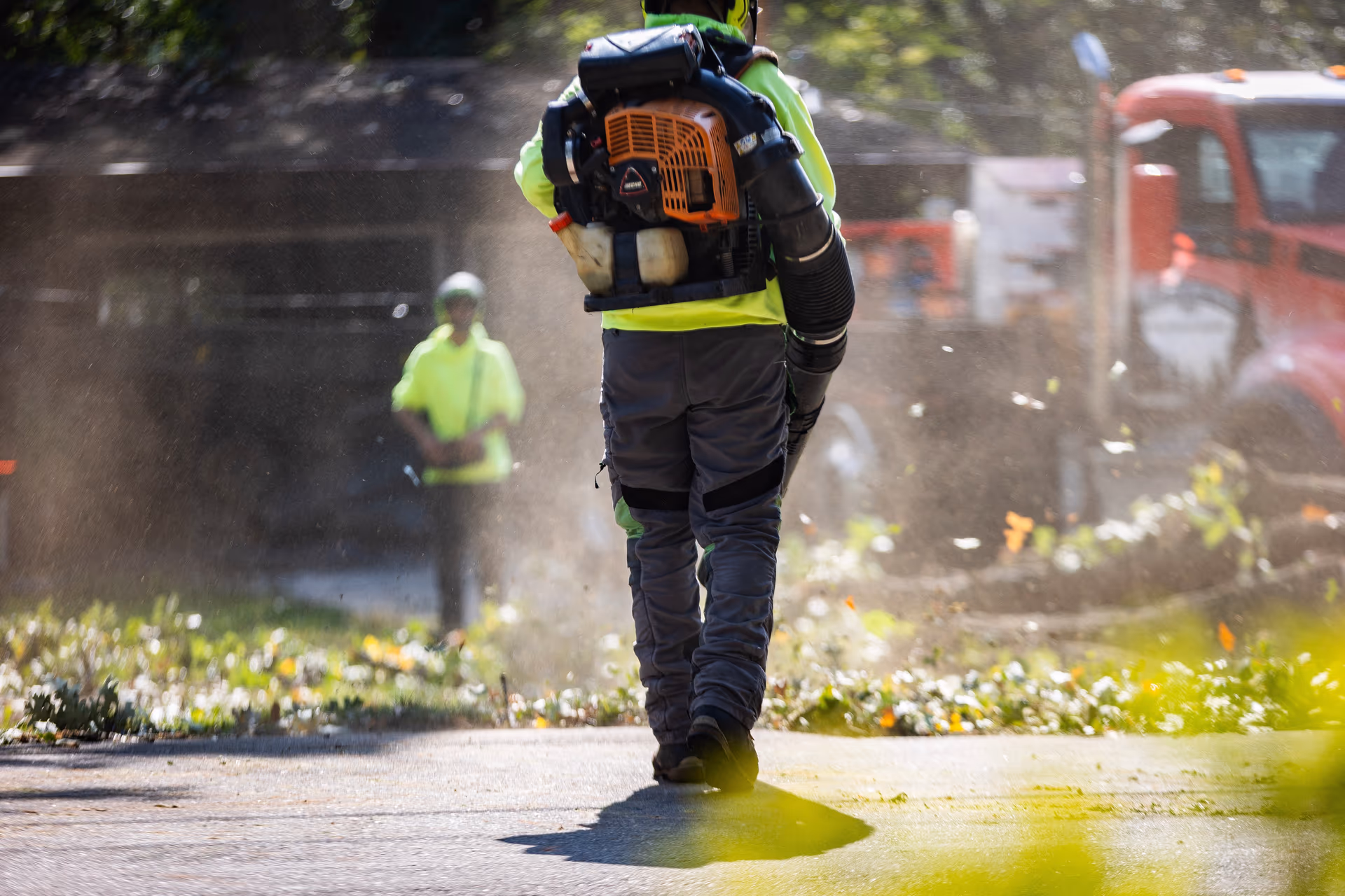 Crew member clearing debris during a scheduled maintenance visit