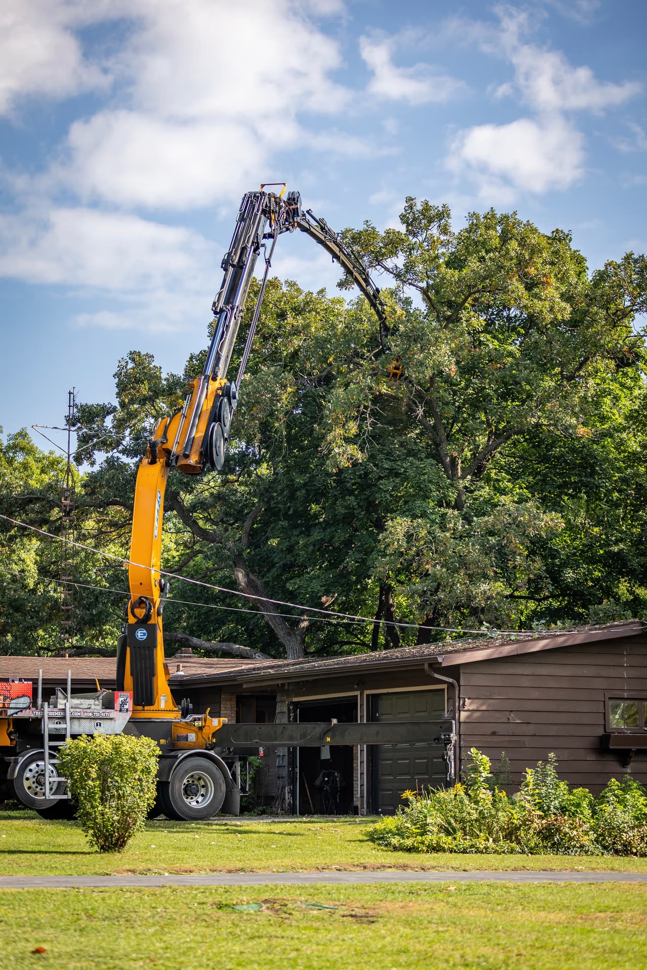 Grapple Saw Lifting a Limb Clear of a Roof