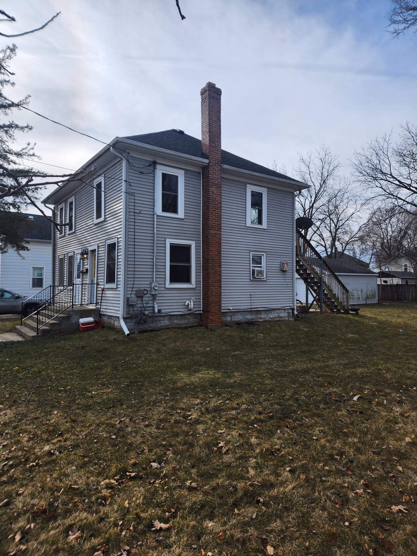 ISA Certified Arborist assessing trees on a Janesville, Wisconsin property