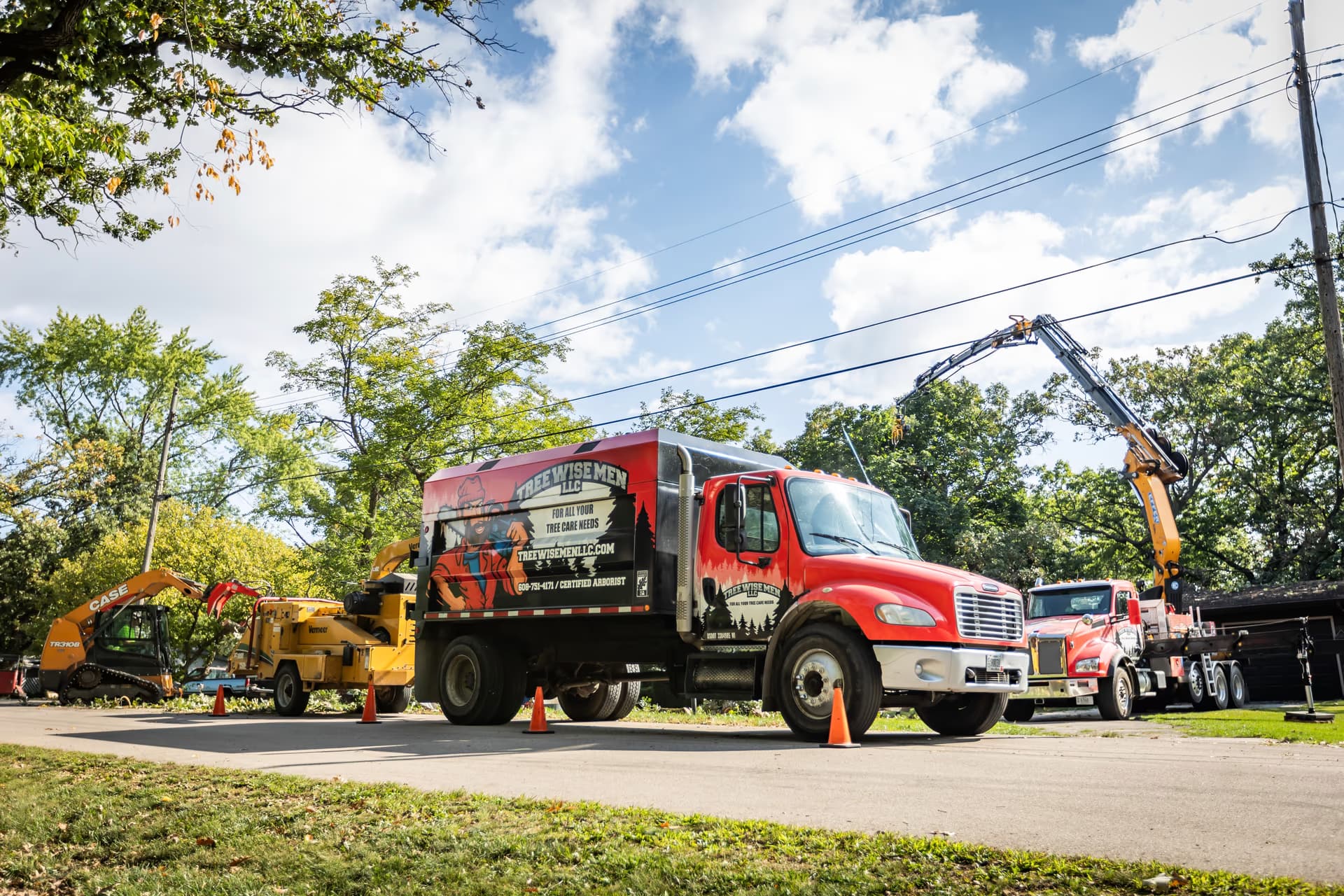 Tree Wise Men truck fleet and chipper on a commercial property in Janesville, Wisconsin